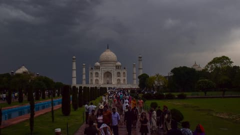 People gather at the Taj Mahal on a cloudy and rainy day during the summer season, in Agra, Uttar Pradesh, Thursday, April 30, 2026.