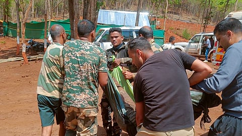 Security personnel and others carry mortal remains of one of the four police personnel who were killed after an improvised explosive device (IED) went off while they were trying to neutralise it during a demining operation, in Kanker district, Chhattisgarh, Saturday, May 2, 2026.