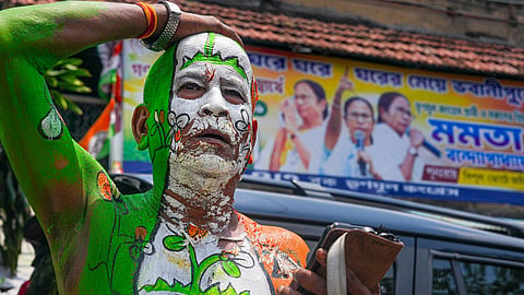 A TMC worker with party symbols painted on his body reacts to the Bengal assembly election results in Kolkata, May 4, 2026.