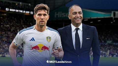 John Stones in a Leeds United shirt while standing next to 49ers figure, Paraag Marathe, outside of Elland Road.