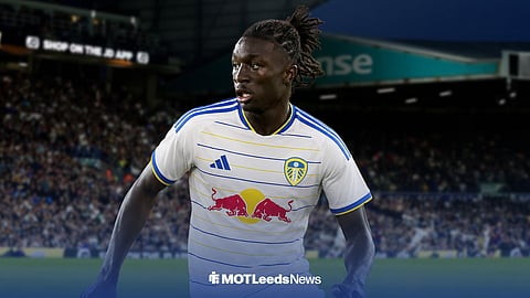 Mateus Mane running while looking left in Leeds United home kit ahead of Elland Road