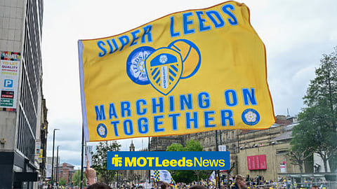 Leeds United fans holding up a Leeds United flag