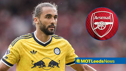 Dominic Calvert-Lewin playing for Leeds United looking at an Arsenal badge