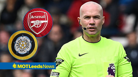 Paul Tierney refereeing looking towards circle insets of Arsenal and Leeds United badges