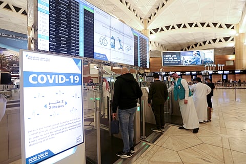 FILE PHOTO: Saudi nationals scan their documents at a digital-Immigration gate at the King Khalid International Airport, after Saudi authorities lifted the travel ban on its citizens after fourteen months due to coronavirus disease (COVID-19) restrictions, in Riyadh, Saudi Arabia, May 16, 2021. 