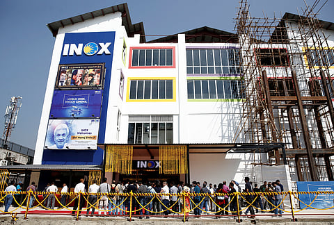 FILE PHOTO: Members of media and Jammu and Kashmir government officials wait to enter a multi-screen cinema hall run by India's leading multiplex chain Inox before its inauguration in Srinagar September 20, 2022. 