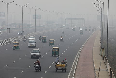 FILE PHOTO: Vehicles are seen on a highway on a smoggy morning in New Delhi, India, December 2, 2021. 
