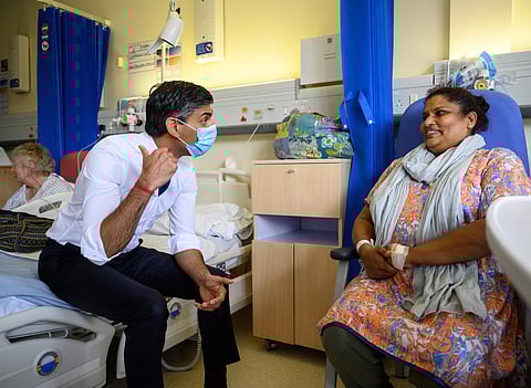 British Prime Minister Rishi Sunak takes speaks with patient Sreeja Gopalan as he visits Croydon University Hospital on October 28, 2022 in London, Britain. 