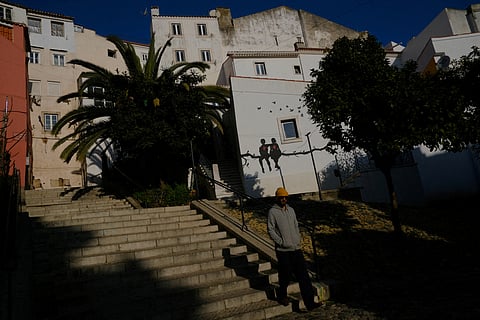 FILE PHOTO: A person walks in Alfama neighbourhood in Lisbon, Portugal, February 16, 2023. 