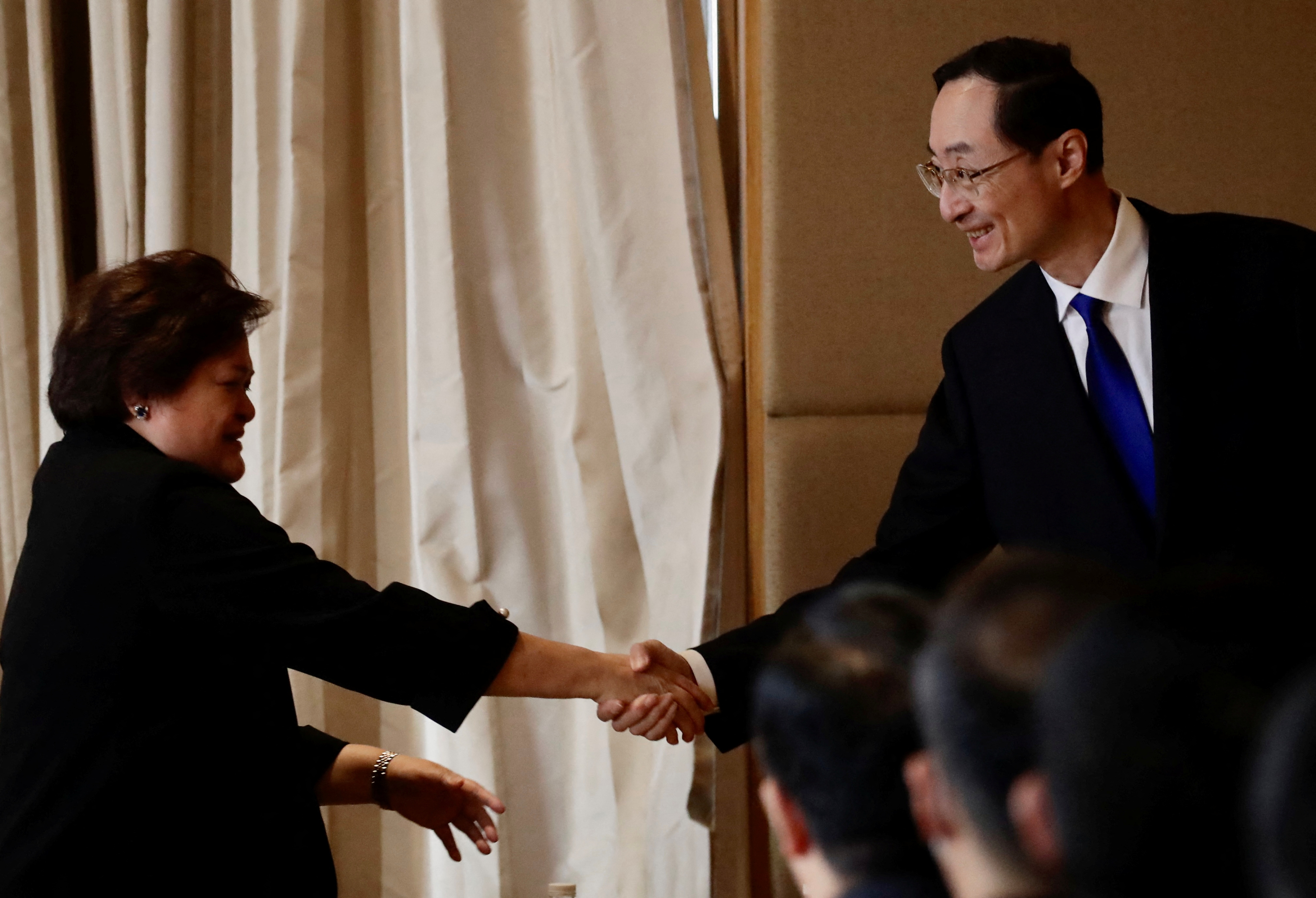 Philippines Undersecretary for Bilateral Relations and ASEAN Affairs of the Department of Foreign Affairs Theresa Lazaro shakes hands with China's Vice Foreign Minister Sun Weidong during the Bilateral Consultations Mechanism (BCM) on the South China Sea in Manila, Philippines, March 24, 2023. 