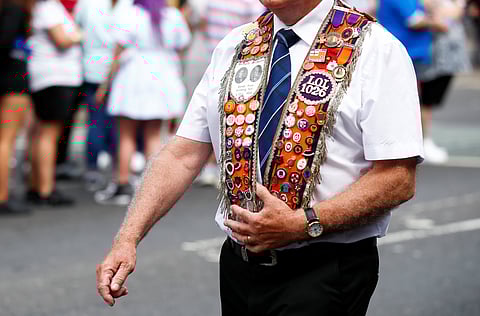 FILE PHOTO: An Orange Order member joins the unionist Twelfth celebrations in Belfast, Northern Ireland, July 12, 2021. 