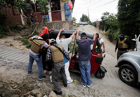 FILE PHOTO: Members of Honduras' DIPAMPCO (Police Anti Maras and Gangs Against Organised Crime Directorate) frisk people while doing rounds in a low-income neighbourhood, after President Xiomara Castro declared a national security emergency implementing a new plan to combat a rising number of cases of extortion by violent criminal groups operating across the country, in Tegucigalpa, Honduras November 26, 2022. 
