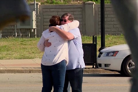 People embrace after an "active police situation" that included mass casualties at Old National Bank in Louisville, Kentucky, U.S. April 10, 2023 in a still image from video. 