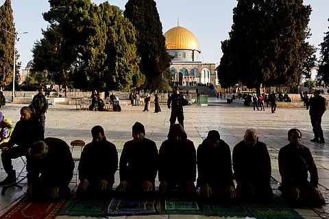 Palestinian men pray at Al-Aqsa mosque, also known to Jews as the Temple Mount, as Israeli security forces take position at the compound, while tension arises during clashes with Palestinians in Jerusalem's Old City, April 5, 2023. 