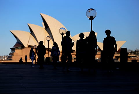 FILE PHOTO: People walk in front of the Sydney Opera House, Australia, November 2, 2016. 