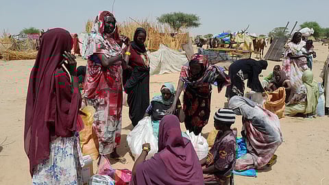 Sudanese refugees who have fled the violence in their country gather to receive food supplements from World Food Programme (WFP), near the border between Sudan and Chad, in Koufroun, Chad April 28, 2023. 