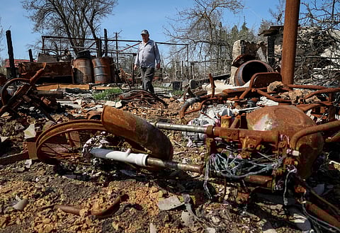 Local resident Mykola Lobko, 72, stands among remains of his house destroyed last year by a military strike in the village of Studenok, Kharkiv region, Ukraine April 10, 2023. 