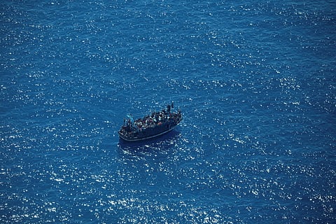 The boat in distress with about 400 people on board is pictured in Central Mediterranean in this handout obtained by Reuters on April 10, 2023. 