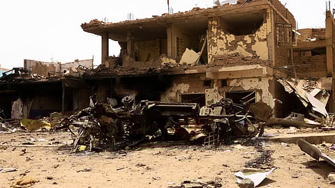 A damaged car and buildings are seen at the central market during clashes between the paramilitary Rapid Support Forces and the army in Khartoum North, Sudan. April 27, 2023. 