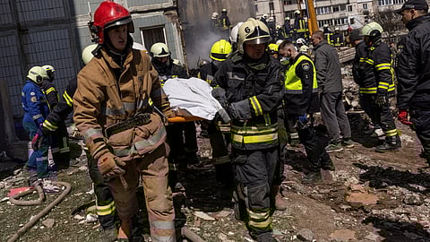 Rescuers carry a covered body as they work at the site of a heavily damaged residential building hit by a Russian missile, amid Russia's attack on Ukraine, in the town of Uman, Cherkasy region, Ukraine April 28, 2023. 
