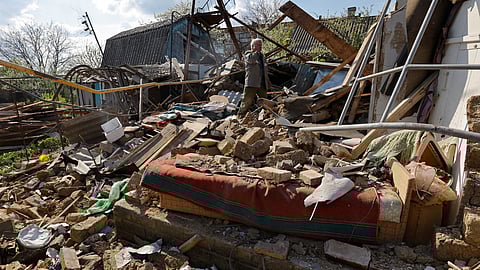 Local resident Nikolai Danko, 63, clears the rubble at the site of his house destroyed by recent shelling in the course of Russia-Ukraine conflict, in the settlement of Panteleimonivka in the Donetsk region, Russian-controlled Ukraine, April 27, 2023. 