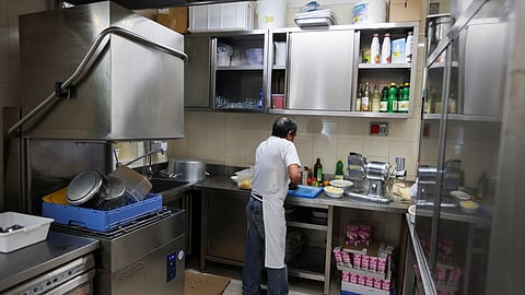 A migrant worker prepares food ar a restaurant prior to lunch time, in Milan, Italy, April 26, 2023. 
