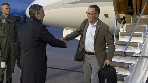 Swiss Federal Councillor Ignazio Cassis, left, welcomes Christian Winter, Swiss Ambassador of Sudan, at the Bern-Belp Airport in Belp, Switzerland, Tuesday, April 25, 2023. 