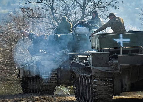 Ukrainian service members ride tanks, as Russia's attack on Ukraine continues, near the front line city of Chasiv Yar, Ukraine April 10, 2023. 