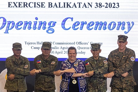 Philippines Exercise Director Major General Marvin Licudine, Philippine Military Chief Andres Centino, U.S. Embassy representative Heather Variava, Philippine Military Deputy Chief of Staff for Education, Training and Development Major General Noel Beleran, and U.S. Exercise Director representative Major General Eric Austin link arms during the opening ceremony of the annual Philippines-U.S. joint military exercises or Balikatan, at the Armed Forces of the Philippines headquarters, in Quezon City, Metro Manila, Philippines, April 11, 2023. 