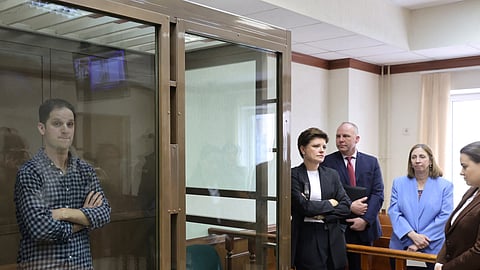 FILE PHOTO: Wall Street Journal reporter Evan Gershkovich, who was detained in March while on a reporting trip and charged with espionage, stands behind a glass wall of an enclosure for defendants, while U.S. Ambassador to Russia Lynne Tracy and lawyers Tatyana Nozhkina and Maria Korchagina appear in a courtroom before a hearing to consider an appeal against Gershkovich's detention, in Moscow, Russia April 18, 2023. 