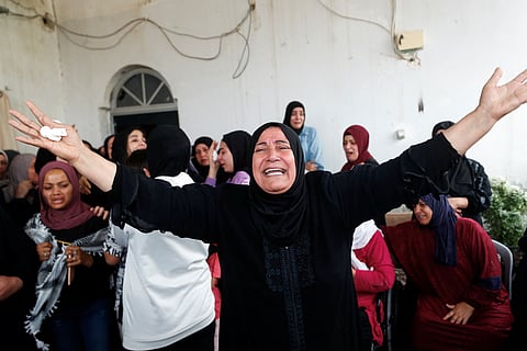 Relatives react during the funeral of a Palestinian who was killed during an Israeli raid, near Jericho in the Israeli-Occupied West Bank, April 10, 2023. 