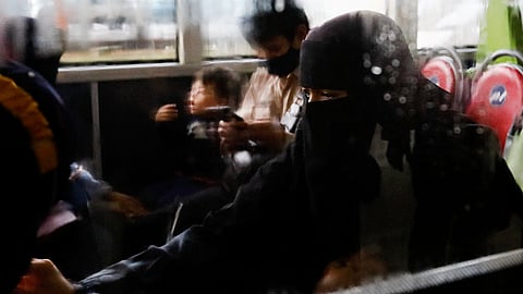 An Indonesian citizen evacuated from Sudan sits in a bus after she arrives at the Soekarno-Hatta Airport in Tangerang, on the outskirts of Jakarta, Indonesia, April 28, 2023. 