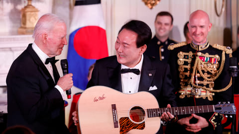 U.S. President Joe Biden gifts a guitar signed by artist Don McLean to South Korea's President Yoon Suk Yeol at an official State Dinner, during Yoon Suk Yeol's visit, at the White House in Washington, U.S. April 26, 2023. 