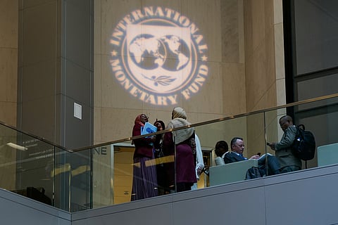 People attend the 2023 Spring Meetings inside the International Monetary Fund in Washington, U.S., April 12, 2023. 
