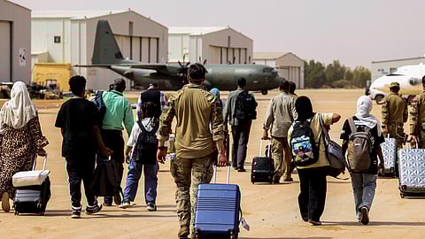 British nationals walk to board an RAF aircraft, during the evacuation to Cyprus, at Wadi Seidna Air Base in Sudan April 27, 2023. 