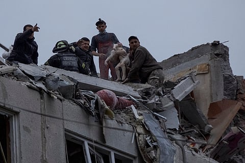 Emergency workers and volunteers rescue a child at a site of an apartment building damaged by a Russian military strike, amid Russia's attack on Ukraine, in Sloviansk, Donetsk region, Ukraine April 14, 2023. 