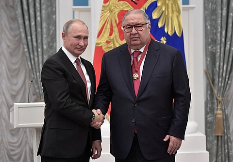 FILE PHOTO: Russian President Vladimir Putin (L) shakes hands with Russian businessman and founder of USM Holdings Alisher Usmanov during an awarding ceremony at the Kremlin in Moscow, Russia November 27, 2018. 