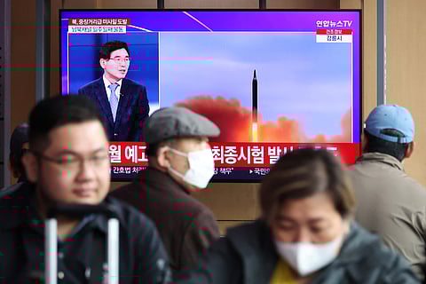 People watch a TV broadcasting a news report on North Korea firing a ballistic missile of intermediate range or longer, at a railway station in Seoul, South Korea, April 13, 2023. 
