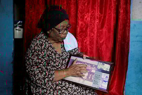 Siti Zabidah Muhammad Rasyid, 66, points at her son Razali Ahmad who was sentenced to death 23 years ago, in a photograph, in Gombak, Malaysia April 4, 2023. 
