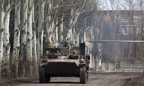 An armoured military vehicle speeds through Chasiv Yar during heavy fighting at the fronttline of Bakhmut and Chasiv Yar, Ukraine, April 9, 2023. 