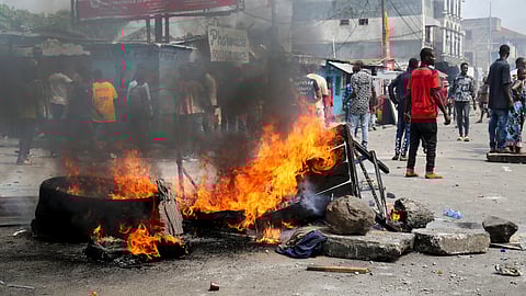 Tires and other objects burn as anti-government demonstrators take part in a riot after security forces broke up an attempted demonstration organized by the opposition and civil society members over alleged irregularities in voter registration for the upcoming December elections, in Kinshasa, Democratic Republic of Congo, May 20, 2023. 