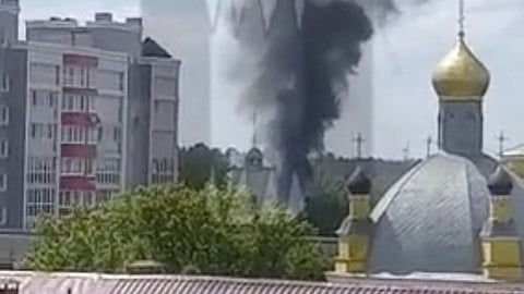 Smoke rises on the site of a helicopter crash in the town of Klintsy in the Bryansk Region, Russia, in this still image taken from video released May 13, 2023. 