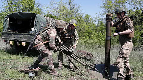 Ukrainian servicemen of the 128th Mountain assault Brigade set up an 120mm mortar during a military training, amid Russia's attack on Ukraine, in Dnipropetrovsk region, Ukraine, May 15, 2023. 