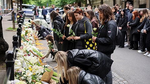 People pay tribute following a school mass shooting, after a boy opened fire on others, killing fellow students and staff in Belgrade, Serbia, May 4, 2023. 