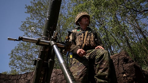 FILE PHOTO: A Ukrainian service member from a 28th separate mechanised brigade named after the Knights of the Winter Campaign of the Armed Forces of Ukraine, prepares to fire a mortar at his positions at a front line, amid Russia's attack on Ukraine, near the city of Bakhmut in Donetsk region, Ukraine May 18, 2023. 