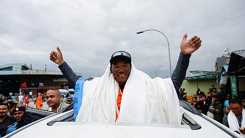 Kami Rita Sherpa, 53, a Nepali mountaineer, waves towards the media personnel upon his arrival after climbing Mount Everest for the 28th time, creating a new record for the most summits of the world’s highest mountain, in Kathmandu, Nepal May 25, 2023. 