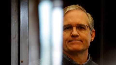 FILE PHOTO: Former U.S. Marine Paul Whelan, who was detained and accused of espionage, stands inside a defendants' cage during his verdict hearing in Moscow, Russia June 15, 2020. 