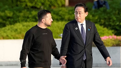 FILE PHOTO: Ukrainian President Volodymyr Zelenskiy is escorted by Japanese Prime Minister Fumio Kishida to the Cenotaph for the Victims of the Atomic Bomb at the Hiroshima Peace Memorial Park, after Zelenskiy was invited to the Group of Seven nations' summit in Hiroshima, Japan, May 21, 2023. 