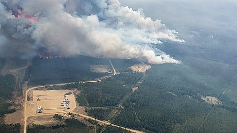 FILE PHOTO: Smoke rises from areas on the southeast side of wildfire EWF-035, part of the Deep Creek Wildfire Complex which is being tackled by helicopters near Shining Bank, Alberta, Canada May 19, 2023. 