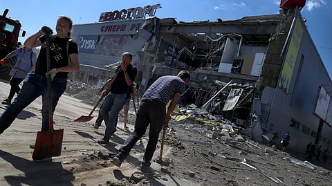FILE PHOTO: Local residents remove debris from a supermarket in a shopping mall damaged by a Russian missile strike, as Russia's attack on Ukraine continues, in Kharkiv, Ukraine June 8, 2022. 